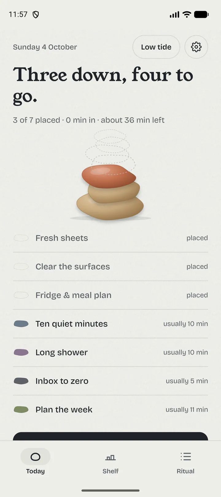 Hafta app screen: a Sunday reset in progress, three of seven stones placed on the cairn